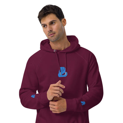 Model wearing a maroon Unisex Bio-Raglan-Hoodie N°3 with blue logo, showcasing casual style and comfort.