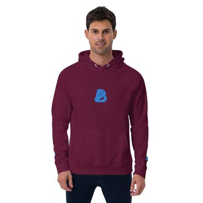 Unisex Bio-Raglan-Hoodie N°3 in burgundy with blue logo, worn by a person, showcasing comfort and casual style.