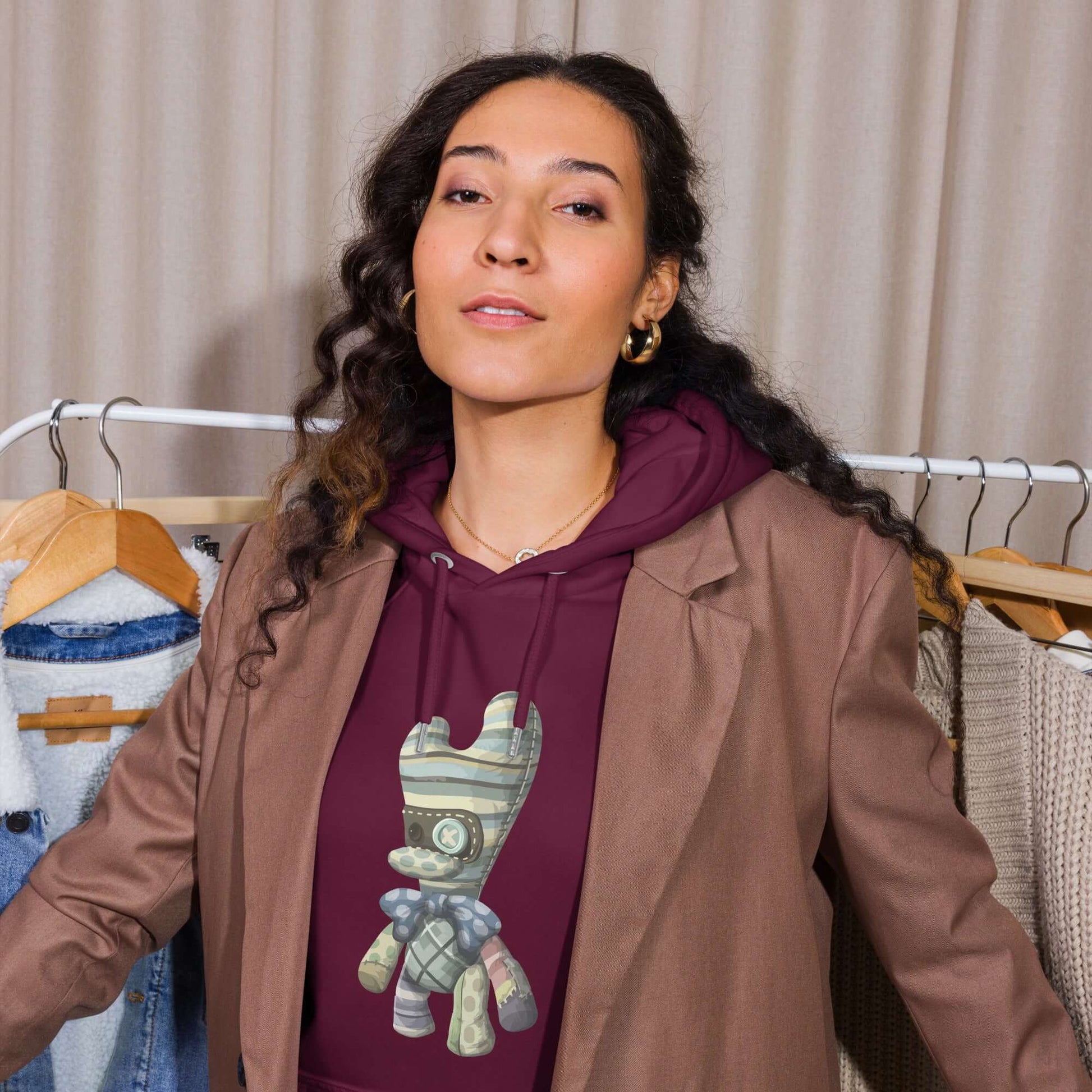 Woman wearing Unisex Bio-Raglan-Hoodie with stylish blazer, showcasing comfort and versatile fashion.