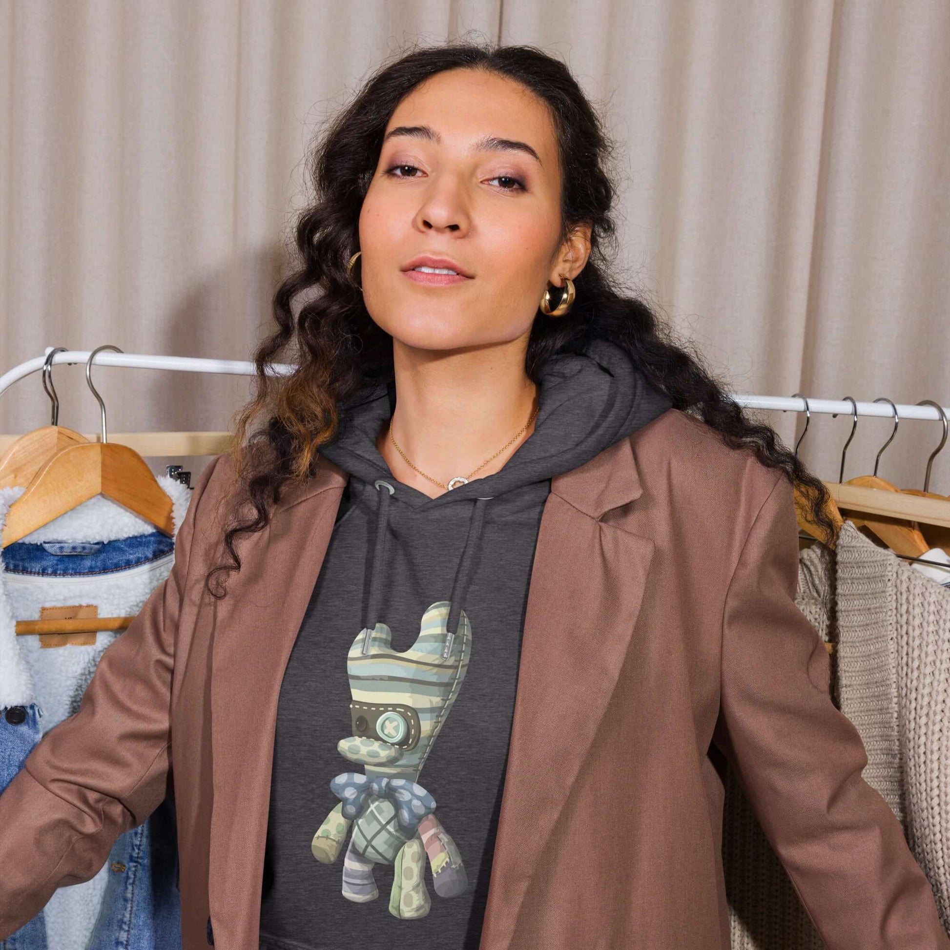 Person wearing Unisex Bio-Raglan-Hoodie under a blazer in a wardrobe setting.