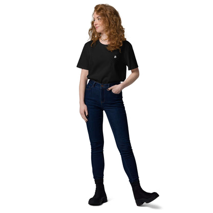 Unisex-Bio-Baumwoll-T-Shirt N°2 in black worn by a person standing with hands in pockets.