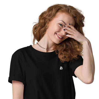 Woman wearing Unisex-Bio-Baumwoll-T-Shirt N°2 in black, smiling with hand over face