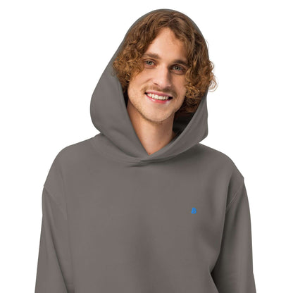 Person wearing Schwerer Oversized Hoodie in gray with hood up, showcasing its comfortable fit and soft fabric.