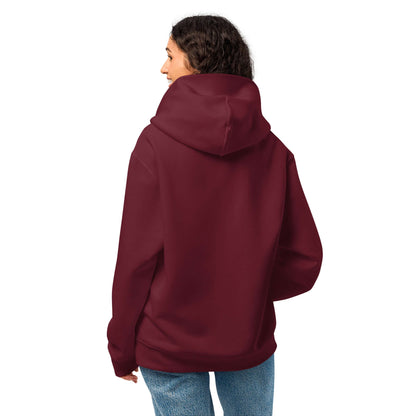 Woman wearing Schwerer Oversized Hoodie in maroon, showcasing its soft, thick fabric and relaxed fit perfect for lounging.