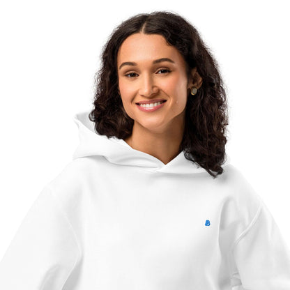 Woman wearing white Schwerer Oversized Hoodie with brushed fleece, showcasing cozy and breathable comfort, no drawstrings.