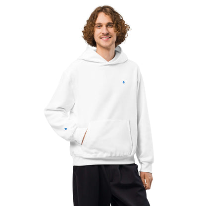 Man wearing a white Schwerer Oversized Hoodie, showcasing its comfortable, casual design with brushed fleece and spacious fit.