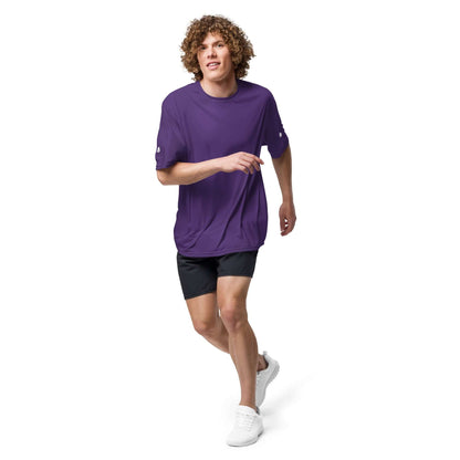 Man in purple Unisex Performance T-Shirt mit Rundhalsausschnitt N°0 running, showcasing athletic design and comfort features.