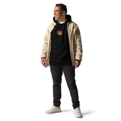 Man wearing Unisex-Kapuzenpullover N°48 with kangaroo pocket, black hoodie under beige jacket, standing confidently against white background.