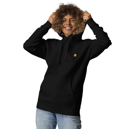 Person wearing Unisex-Kapuzenpullover N°50, a stylish black hoodie with front pocket and cozy hood, ideal for cool evenings.
