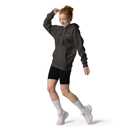 Woman dancing in Unisex-Kapuzenpullover N°50, showcasing its stylish design with a front pocket and warm hood.