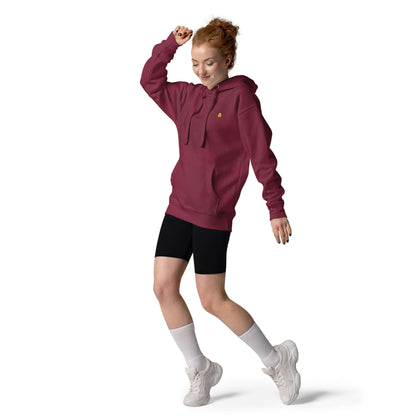 Woman wearing maroon Unisex-Kapuzenpullover N°50, stylish hoodie with front pocket and warm hood, ideal for cool evenings.