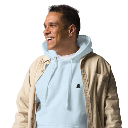 Person wearing Unisex-Kapuzenpullover N°49 in light blue with a beige jacket, showcasing streetwear style.