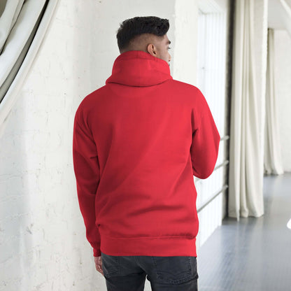Person wearing a red Unisex-Kapuzenpullover N°49 with a warm hood, showcasing the soft streetwear style. Back view in a bright room.