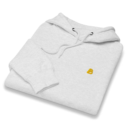 Folded Mittelschwerer Unisex Premium-Hoodie in light gray with a small logo, featuring a soft cotton finish for a stylish and comfortable look.