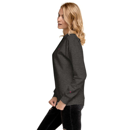 Woman wearing Unisex-Premium-Pullover N°1 in charcoal heather, showcasing ribbed crew neck and soft fleece interior for streetwear style.