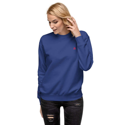 Woman wearing a blue Unisex-Premium-Pullover N°1 with ribbed cuffs and round neck for a stylish streetwear look.
