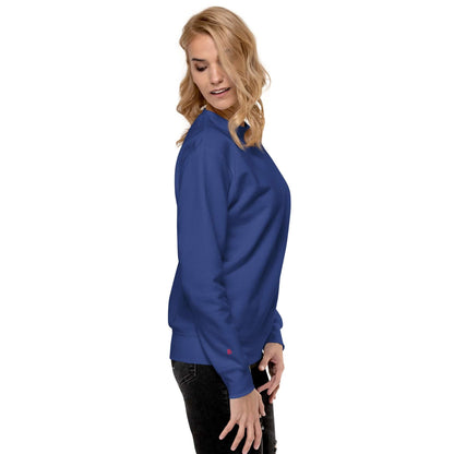 Woman wearing Unisex-Premium-Pullover N°1 in vibrant blue, showcasing casual streetwear style with ribbed neckline and comfortable fit.