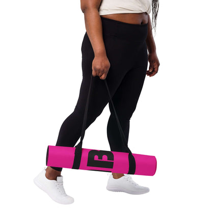 Person carrying Yoga-Matte N°1 in pink with black strap, ideal for training, stretching, or meditating, highlighting style and comfort.