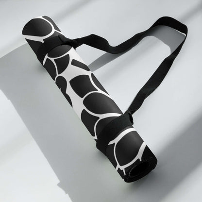 Yoga-Matte N°0 with stylish black and white design, featuring a soft microvelours top and non-slip rubber base, rolled with a carry strap.