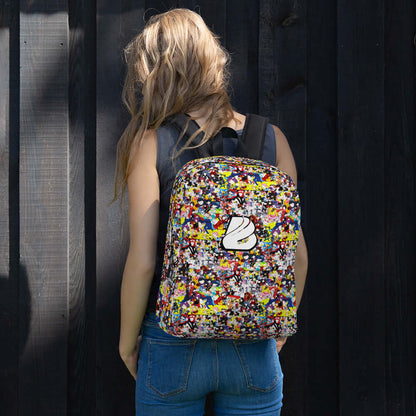 Female model wearing colorful Rucksack N°3 outdoors, showing back view against wooden wall.