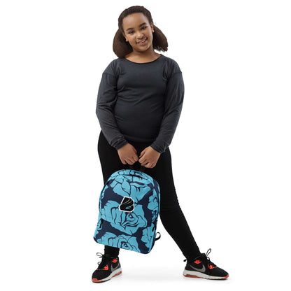 Girl holding Rucksack N°4 with blue floral design, ideal for everyday use and sports, featuring waterproof material.