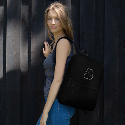 Woman carrying Rucksack N°2, a medium-sized waterproof backpack, perfect for daily use or sports activities, in black color.