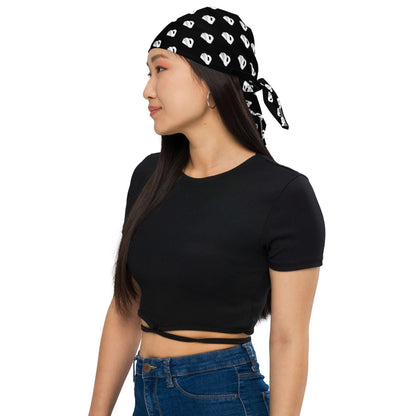 Woman wearing Bandana N°0 as a headband with a casual black top and jeans, showcasing style and versatility.