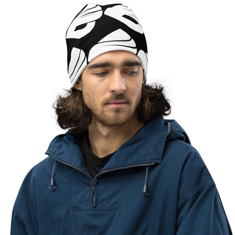 Man wearing a stylish black and white allover beanie, perfect for cold weather and a fashionable outfit.