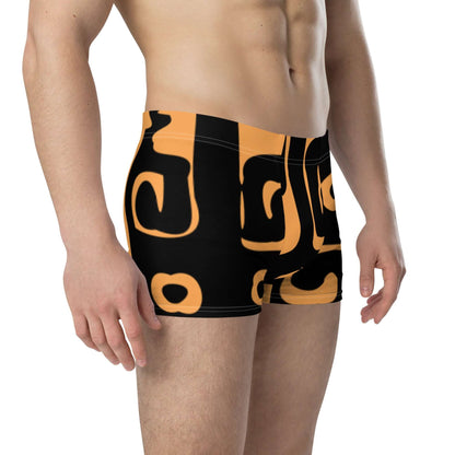 Model wearing Boxer-Briefs N°10 with black and orange design, displaying mid-waist and stretchy 4 cm elastic waistband.