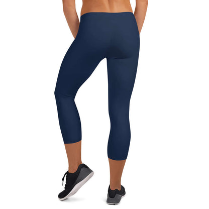 Back view of woman wearing Capri-Leggings N°0 in dark blue, showcasing four-way stretch and comfort.