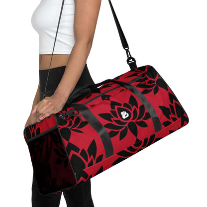 Woman carrying Weekender N°6 in red with black floral design, adjustable shoulder strap, ideal for travel, errands, or gym use.