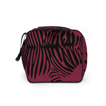 Weekender N°23 in red with black leaf pattern, ideal for travel and gym, featuring adjustable shoulder straps and multiple pockets for organization.