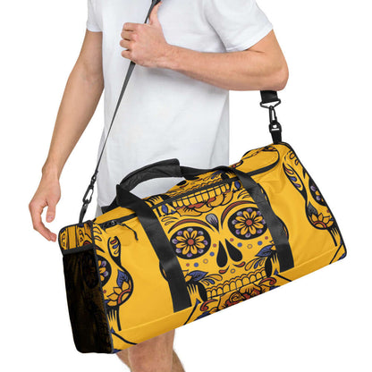 Man carrying stylish yellow Weekender N°1 duffle bag with decorative skull design, suitable for travel and gym use.