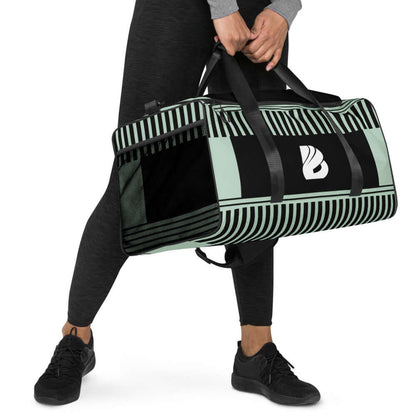 Person holding Weekender N°2, a spacious, versatile bag ideal for travel, daily errands, or gym use, featuring adjustable shoulder straps.