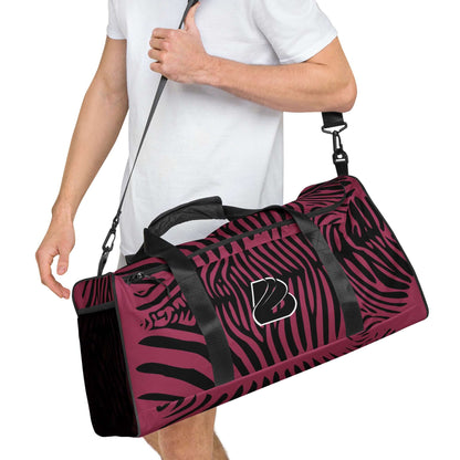 Person carrying Weekender N°23 zebra print bag with adjustable shoulder strap for travel and fitness.