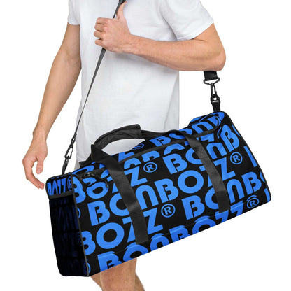Person carrying a blue and black Weekender N°25 travel bag with adjustable strap and spacious design for travel, errands, and gym.