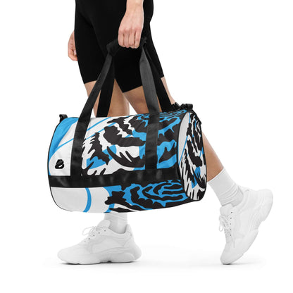 Person carrying Allover-Print-Sporttasche N°4, a durable polyester gym bag with vibrant print, robust material, and waterproof features.