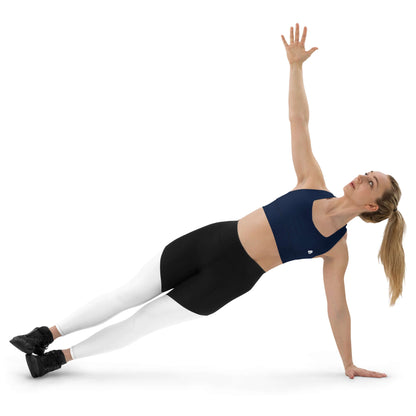 Woman wearing Longline-Sport-BH N°4 performing side plank exercise indoors, showcasing support and style for workouts or streetwear.