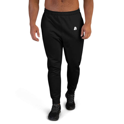 Man wearing Herren-Jogginghose N°5 in black, ideal for jogging and lounging, made from soft cotton blend with polyester and elastane.