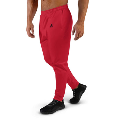 Mann trägt rote Herren-Jogginghose N°6 aus Baumwollmischung, ideal zum Joggen oder Entspannen.