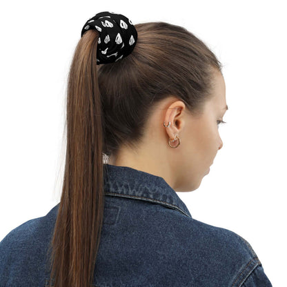 Person wearing a ponytail with a black and white patterned scrunchie, showcasing versatile fashion accessory.