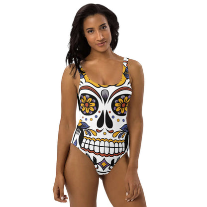 Model wearing Einteiliger Badeanzug N°5 with colorful skull design, perfect for beach or pool.
