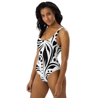 Model wearing Einteiliger Badeanzug N°15 with bold black and white pattern, perfect for beach or pool.