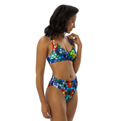 Model wearing vibrant High Waist Bikini N°0 with colorful mosaic pattern for beach or poolside comfort.