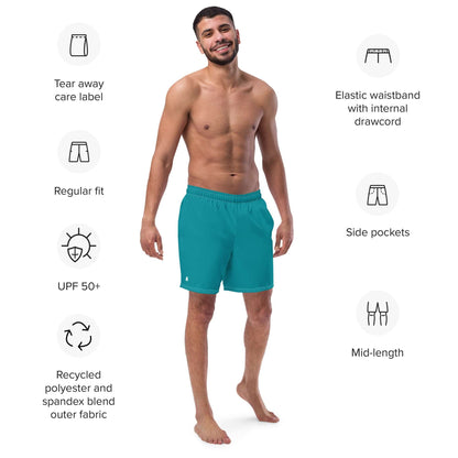 Man wearing Herren-Badehosen N°10, teal color, showcasing features like side pockets, elastic waistband, regular fit, and recycled materials.