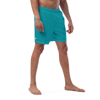 Man wearing Herren-Badehosen N°10, turquoise quick-dry swim shorts, showing side view with elastic waistband and pocket detailing.