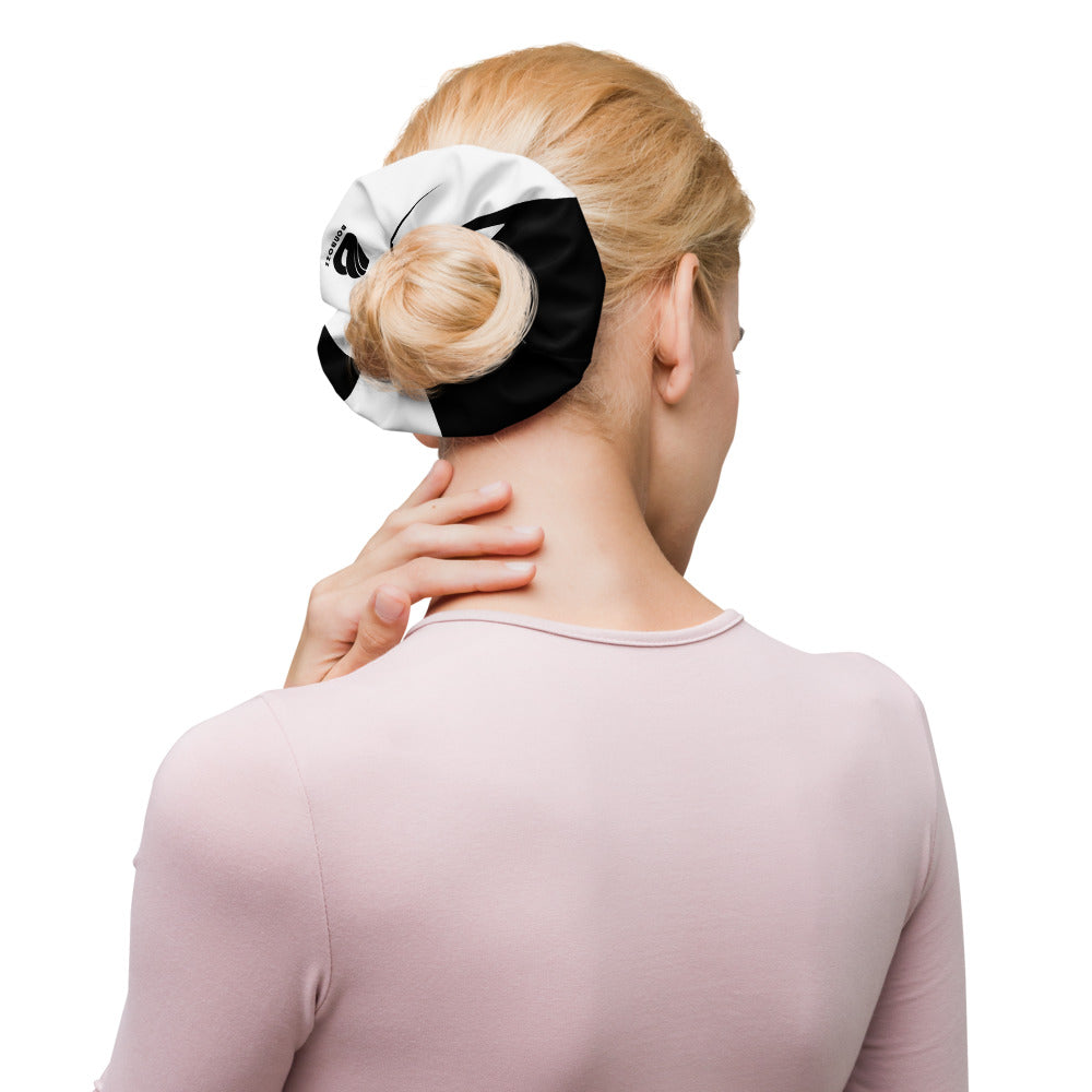 Stylish hair scrunchie holding a bun, adding a trendy touch to any outfit.