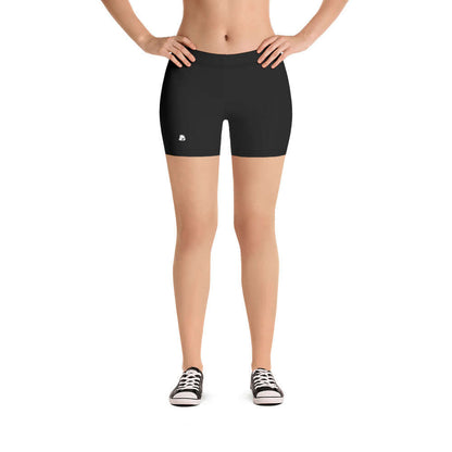 Woman wearing black Shorts N°0 with hands on hips, showcasing stretchy fabric and comfortable fit.