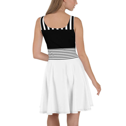 Woman wearing Skater-Kleid N°1, sleeveless black and white dress with striped top and flared skirt, showcasing elegant and vibrant design.