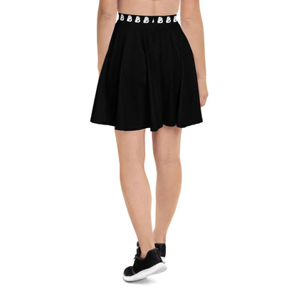 Rear view of person wearing a black Skater-Rock N°7 with elastic waistband, soft fabric, and flattering silhouette.